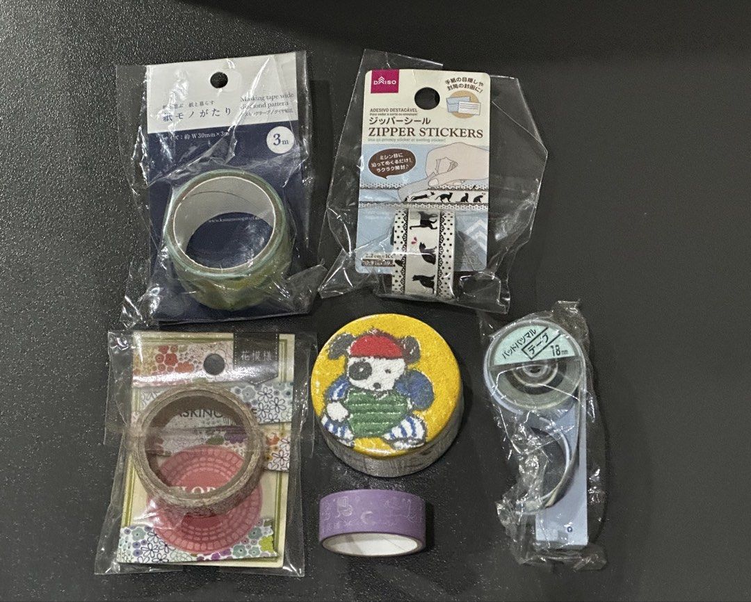 Daiso and Japanese Washi Tapes Bundle (Category: Craft Supplies & Tools) located in Manila. Submitted by sharksfin06 (Listing ID 1456865849, Image 1). Description: - Daiso stationery bundle perfect for crafting and journaling. - Includes zipper stickers for sealing envelopes. - Three decorative washi tapes: - Green patterned tape - Dog and cat design set - Floral patterned tape - One small roll of purple tape. - One tape dispenser with 18mm tape 