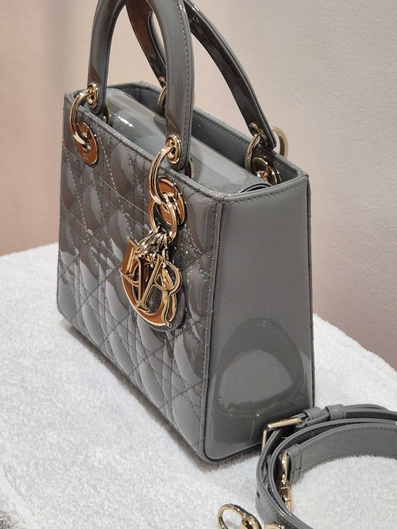 Dior Grey Patent Lady Dior Mini Bag (Category: Luxury Bags & Wallets) located in Quezon City. Submitted by belovedmanila (Listing ID 1456868205, Image 2). Description: - Grey patent leather mini Lady Dior bag - Iconic cannage stitching - Gold-tone hardware with Dior charms - Detachable shoulder strap included - Chic and compact design - Ideal for evenings or elevating any outfit.