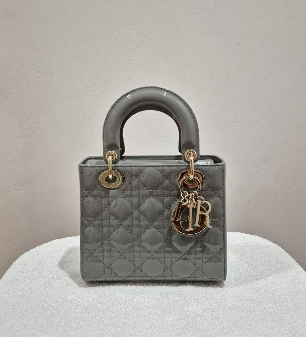 Dior Grey Patent Lady Dior Mini Bag (Category: Luxury Bags & Wallets) located in Quezon City. Submitted by belovedmanila (Listing ID 1456868205, Image 1). Description: - Grey patent leather mini Lady Dior bag - Iconic cannage stitching - Gold-tone hardware with Dior charms - Detachable shoulder strap included - Chic and compact design - Ideal for evenings or elevating any outfit.