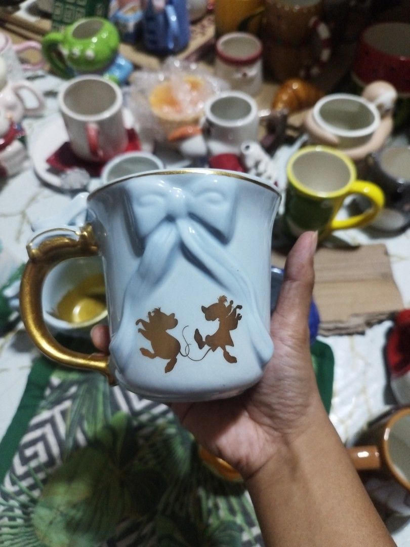 Disney Cinderella Zak! Mug with Gold Handle (Category: Coffee & Tea Tableware) located in Manila. Submitted by silverwhale_cafa21 (Listing ID 1456874085, Image 2). Description: - Light blue mug featuring Cinderella and her mice friends - Elegant gold handle - Made by Zak! Designs - Ideal for Disney fans and collectors - Perfect for coffee or tea - Dishwasher and microwave safe.