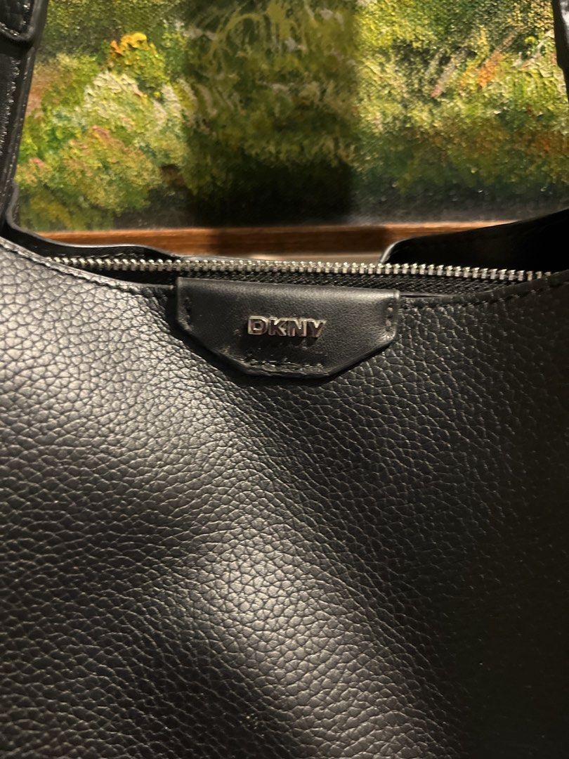 DKNY Black Leather Tote Bag (Category: Tote Bags) located in Manila. Submitted by jigzy26 (Listing ID 1456809137, Image 2). Description: Bought this DKNY from personal shopper from Canada last year for P5,500, used this for like twice in the office and stored afterwards (coz i have so many other bags) Selling it based on Carousell suggested price this DKNY for P950 is such a great steal!🥰 - Brand: DKNY bought this last year used this only twice 