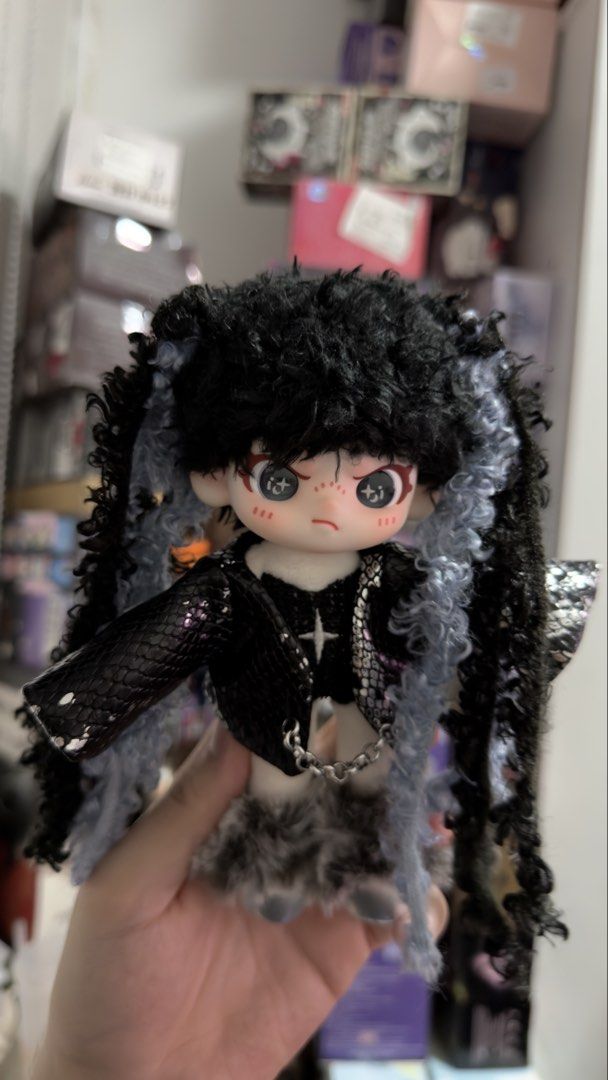 Dora Plush Doll (Category: Plushies & Soft Toys) located in Manila. Submitted by blindboxlife3195 (Listing ID 1456940596, Image 2). Description: - Cute gothic doll - Black curly hair with blue streaks - Black snakeskin jacket - Furry skirt - Chain detail on the front - Adorable face with freckles and big eyes - Ideal for doll collectors or unique display.