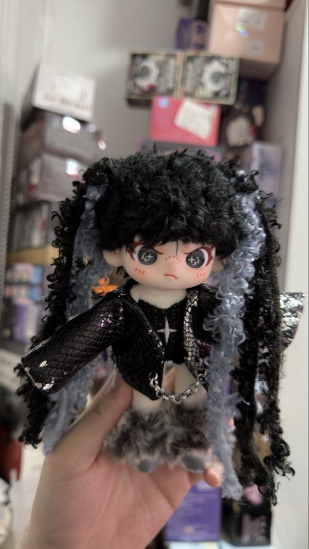 Dora Plush Doll (Category: Plushies & Soft Toys) located in Manila. Submitted by blindboxlife3195 (Listing ID 1456940596, Image 1). Description: - Cute gothic doll - Black curly hair with blue streaks - Black snakeskin jacket - Furry skirt - Chain detail on the front - Adorable face with freckles and big eyes - Ideal for doll collectors or unique display.