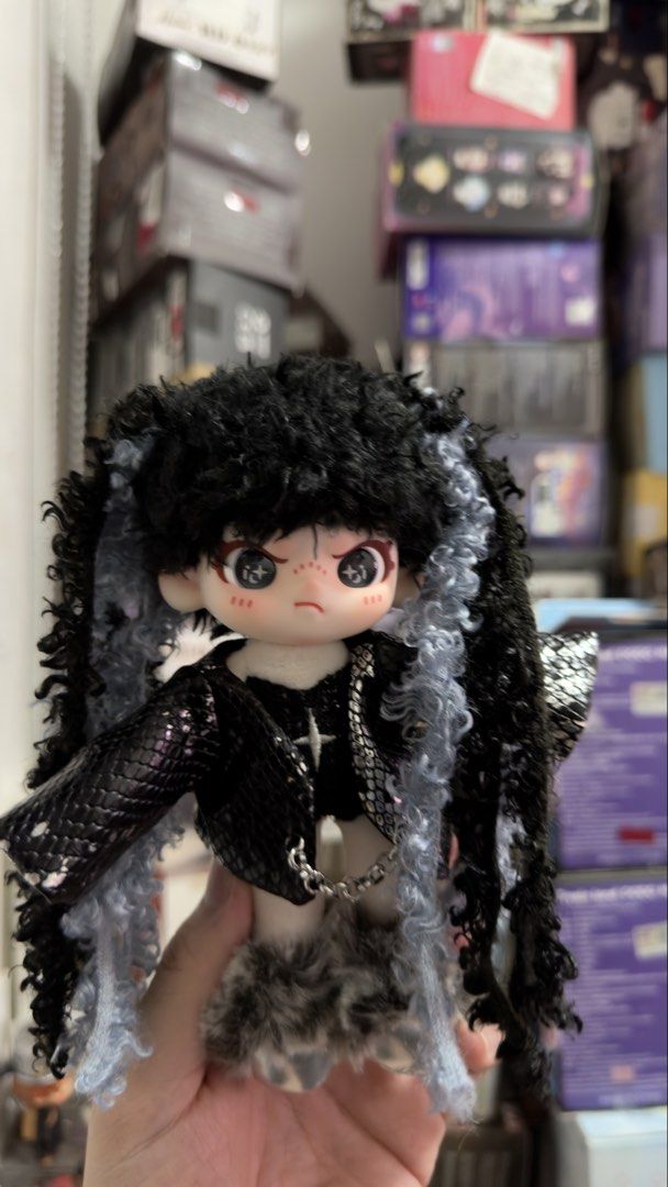 Dora Plush Doll (Category: Plushies & Soft Toys) located in Manila. Submitted by blindboxlife3195 (Listing ID 1456940596, Image 3). Description: - Cute gothic doll - Black curly hair with blue streaks - Black snakeskin jacket - Furry skirt - Chain detail on the front - Adorable face with freckles and big eyes - Ideal for doll collectors or unique display.