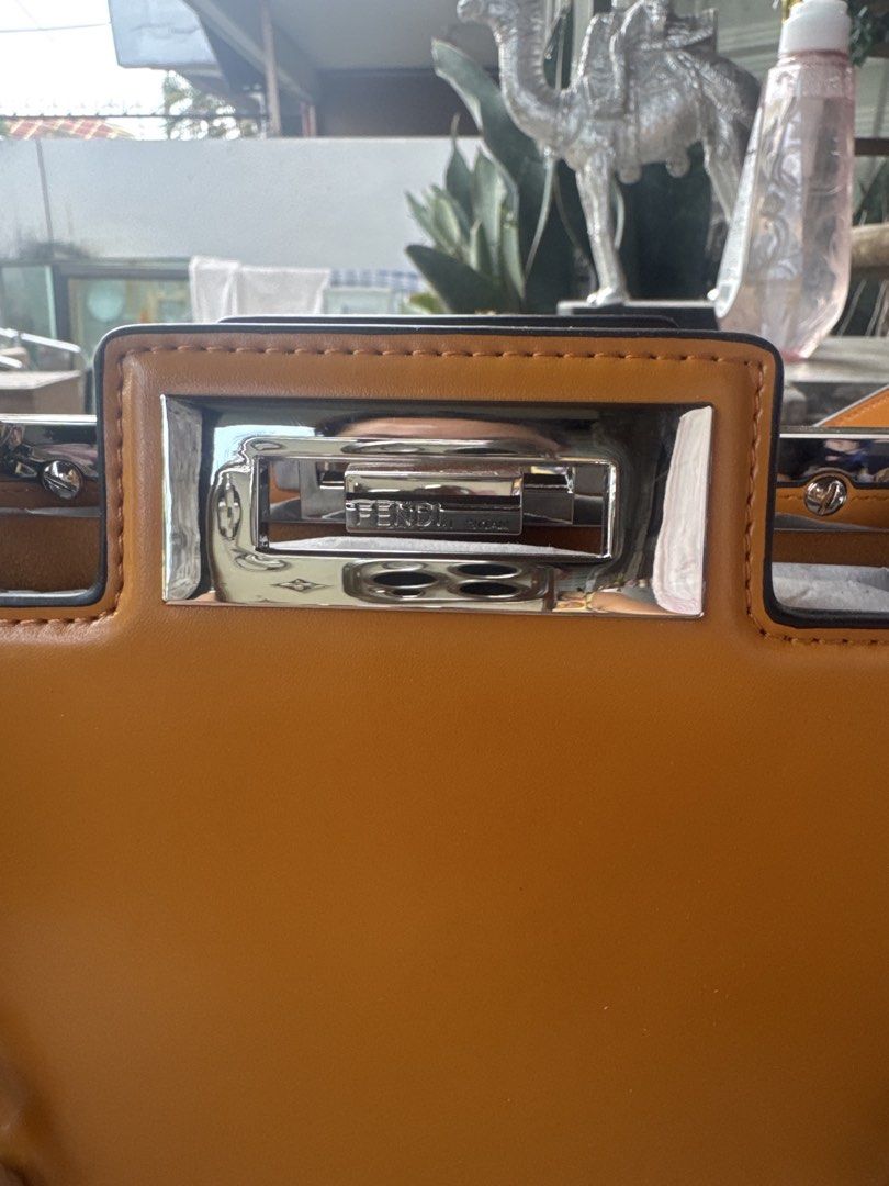 Fendi Peekaboo Bag - Tan Leather with Chain Strap (Category: Laptop Bags & Sleeves) located in Angeles City. Submitted by migs_font29 (Listing ID 1456926134, Image 2). Description: - Authentic Fendi Peekaboo bag - Color: Tan leather - Features a silver chain strap with Fendi logo links - Top handle - Turn-lock closure with Fendi engraving - Structured silhouette - Versatile for day or night use.