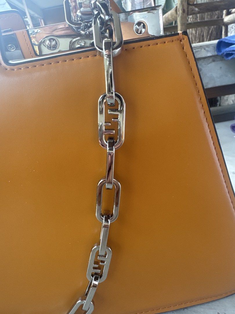 Fendi Peekaboo Bag - Tan Leather with Chain Strap (Category: Laptop Bags & Sleeves) located in Angeles City. Submitted by migs_font29 (Listing ID 1456926134, Image 3). Description: - Authentic Fendi Peekaboo bag - Color: Tan leather - Features a silver chain strap with Fendi logo links - Top handle - Turn-lock closure with Fendi engraving - Structured silhouette - Versatile for day or night use.