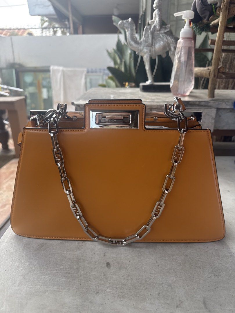 Fendi Peekaboo Bag - Tan Leather with Chain Strap (Category: Laptop Bags & Sleeves) located in Angeles City. Submitted by migs_font29 (Listing ID 1456926134, Image 1). Description: - Authentic Fendi Peekaboo bag - Color: Tan leather - Features a silver chain strap with Fendi logo links - Top handle - Turn-lock closure with Fendi engraving - Structured silhouette - Versatile for day or night use.