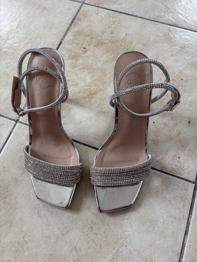 Gibi Silver Long Strap Heels (Category: Heels) located in Pasig City. Submitted by adikinsdeclutter (Listing ID 1456820857, Image 1). Description: Only used once Minor flaw: missing diamonds in some parts but not visible from afar.