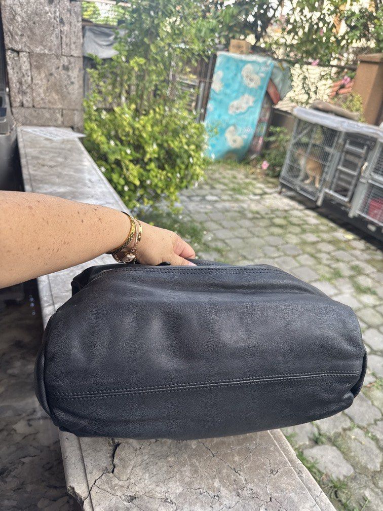 Givenchy Black Leather Nightingale Handbag (Category: Camera Bags & Carriers) located in Angeles City. Submitted by migs_font29 (Listing ID 1456947278, Image 2). Description: - Authentic black leather Givenchy Nightingale bag - Iconic and versatile design - Features both top handles and a detachable shoulder strap - Ample interior space for daily essentials - Smooth and fully functional zippers - A timeless and stylish accessory for any fashion-c