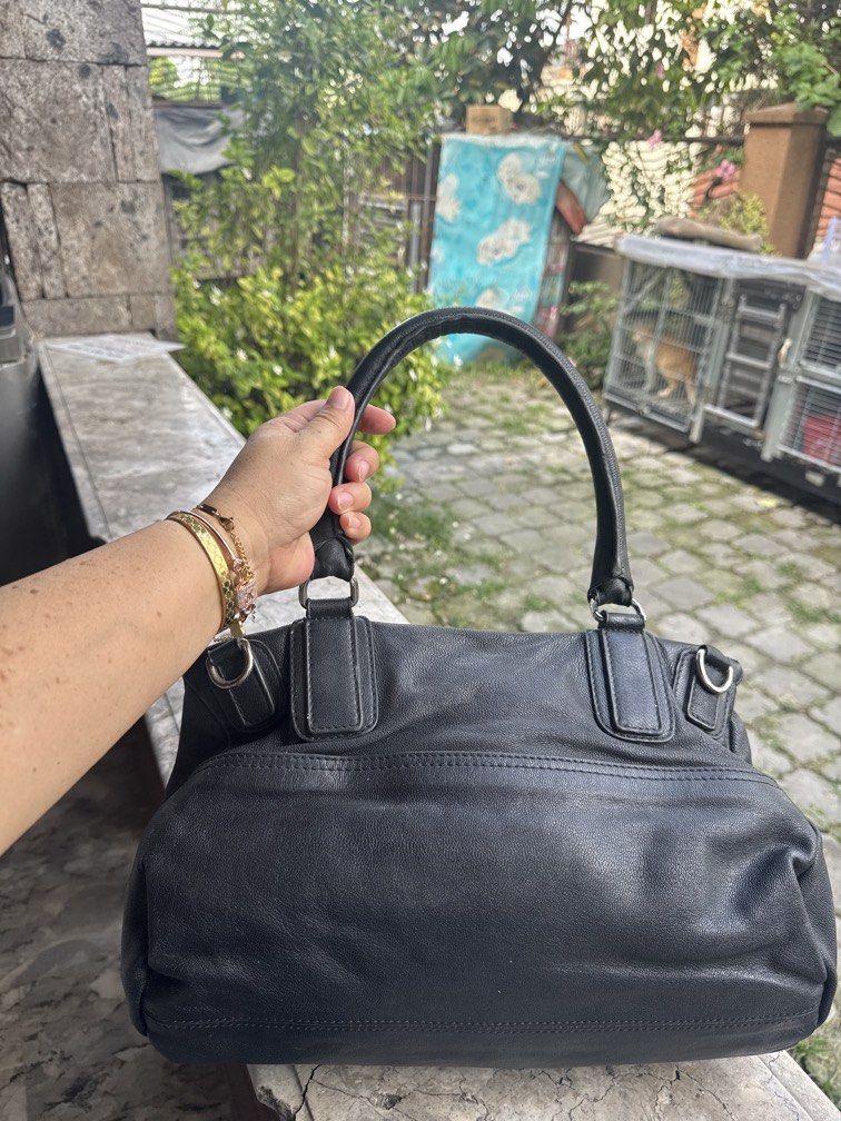 Givenchy Black Leather Nightingale Handbag (Category: Camera Bags & Carriers) located in Angeles City. Submitted by migs_font29 (Listing ID 1456947278, Image 3). Description: - Authentic black leather Givenchy Nightingale bag - Iconic and versatile design - Features both top handles and a detachable shoulder strap - Ample interior space for daily essentials - Smooth and fully functional zippers - A timeless and stylish accessory for any fashion-c