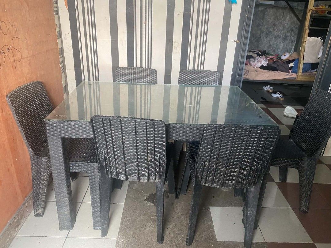 Glass Top Rattan Dining Table with 6 Chairs (Category: Tables & Sets) located in Manila. Submitted by SimplyandJustBy_Maidavao (Listing ID 1456803426, Image 1). Description: - Clear glass top dining table - Includes 6 durable black rattan chairs - Comfortably seats 6 people - Suitable for both indoor and outdoor use - Chairs have minor dust and scuffs, ready for a new home.