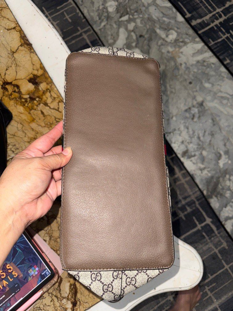 Gucci Monogram Canvas & Leather Dome Satchel Bag (Category: Laptop Bags & Sleeves) located in Angeles City. Submitted by migs_font29 (Listing ID 1456936062, Image 2). Description: - Authentic Gucci GG monogram canvas bag - Brown leather trim - Signature green and red stripe detail - Interior shows some signs of wear and staining - Zipper closure - Serial number visible inside - Made in Italy.