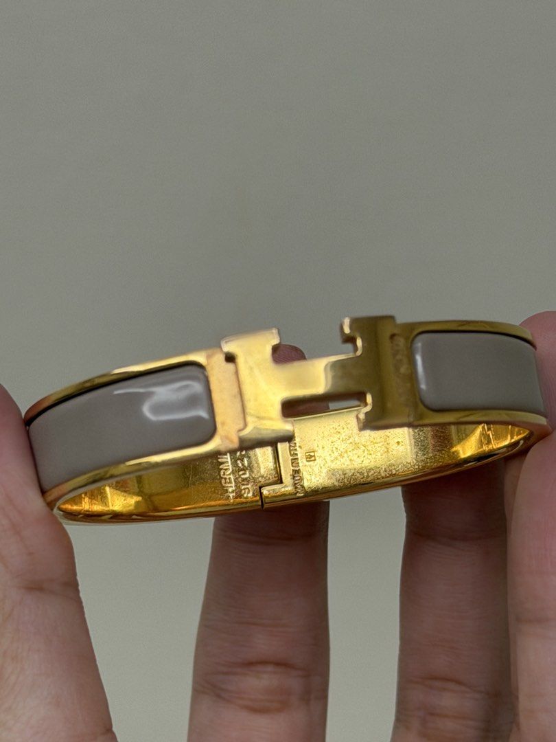 Hermes Clic Clac Etoupe H Bracelet (Category: Luxury Accessories) located in Manila. Submitted by tashvintagefinds (Listing ID 1456932310, Image 2). Description: - Authentic Hermes Clic Clac H Bracelet - Etoupe Color - With dustbag and box - With hairline scratches - Nego.