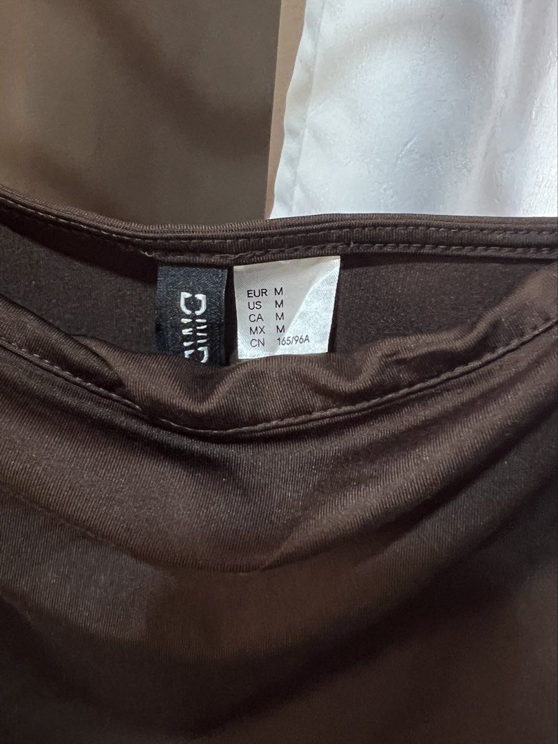 H&M Brown Draped Slip Dress (Category: Dresses) located in Las Pinas. Submitted by reiclutter (Listing ID 1452714084, Image 3). Description: - H&M - Size: Medium (M) - Features: Spaghetti straps, draped front - Condition: Brand new. Never worn but nag loose na yung thread niya sa may strap (need stitching). .