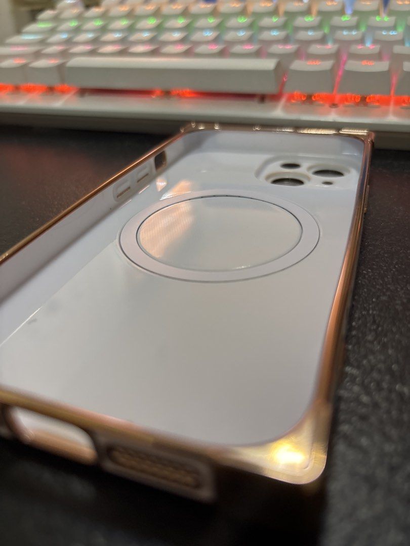 iPhone 15 case (Category: Cases & Sleeves) located in Malabon City. Submitted by luxgoals (Listing ID 1456785657, Image 3). Description: - Designed for iPhone 15 - Stylish white finish with rose gold accents - Features a cute heart design on the back - MagSafe compatible for easy charging and accessory attachment - Sleek and protective - Condition: 4/5 stars.