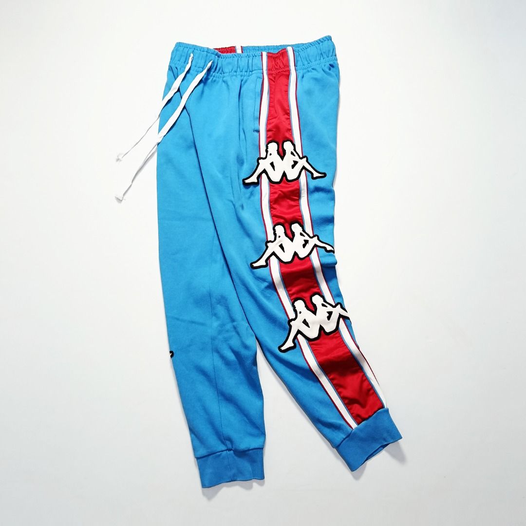 Kappa Logo Tape Track Joggers (Category: Joggers) located in Taytay. Submitted by hoodgrail.vtg (Listing ID 1456843481, Image 3). Description: • Excellent condition - Lightly used • Bold all-over Omini logo side panels with blue/red color blocking • Size on tag: M — best fits 32 • Measurements: 15-17 x 38 in • Leg opening: 5 in elastic • Color rate: 9.5/10 • Issue: None.