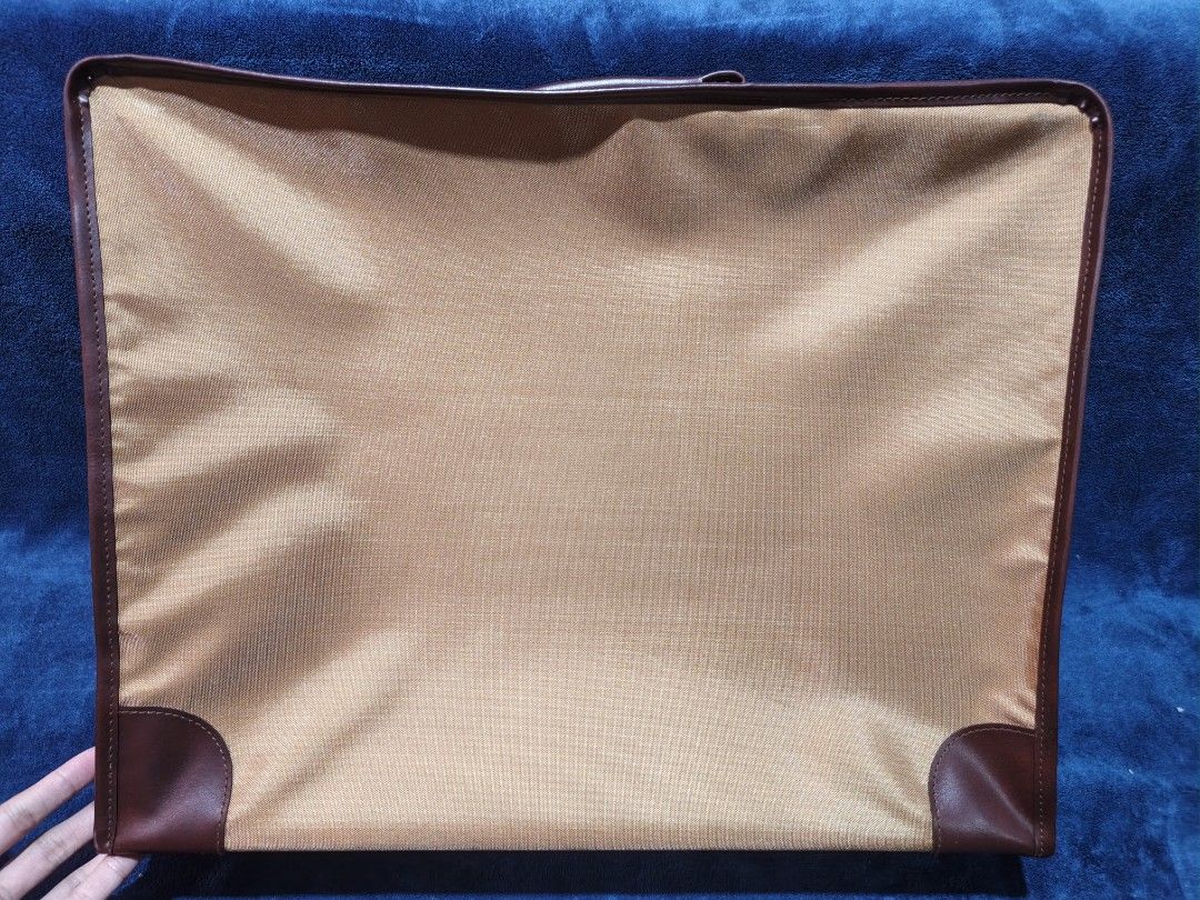 Le Salon Document Bag Briefcase Tan Brown Leather Trim (Category: Briefcases) located in Manila. Submitted by kirstentoyshub (Listing ID 1456850628, Image 3). Description: - Tan document bag with brown leather trim - Top and side handles for versatile carrying - Secure zipper closure - Convenient side slot for a label - Ideal for transporting papers or a slim laptop - Great for work or travel.
