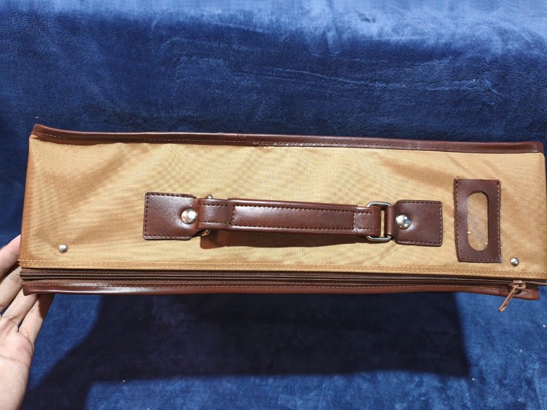 Le Salon Document Bag Briefcase Tan Brown Leather Trim (Category: Briefcases) located in Manila. Submitted by kirstentoyshub (Listing ID 1456850628, Image 2). Description: - Tan document bag with brown leather trim - Top and side handles for versatile carrying - Secure zipper closure - Convenient side slot for a label - Ideal for transporting papers or a slim laptop - Great for work or travel.