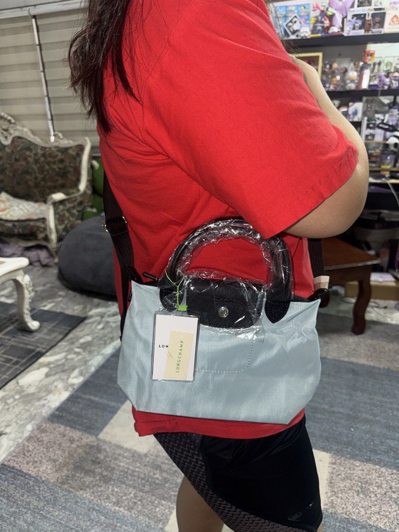 Longchamp Le Pliage Shoulder Bag Light Blue (Category: Carriers & Slings) located in Angeles City. Submitted by migs_font29 (Listing ID 1456908776, Image 1). Description: - Authentic Light Blue Longchamp Le Pliage Bag - Made in France - Classic Leather Handles and Trim - Adjustable Strap - Original Tag Still Attached - Ideal for Everyday Use.