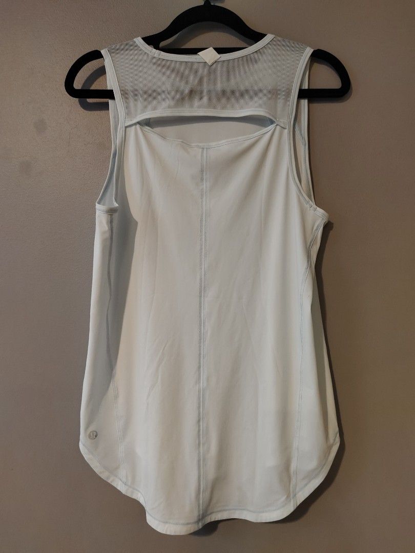 Lululemon Light Blue Mesh Back Tank Top Size 4 (Category: Activewear) located in Muntinlupa City. Submitted by cezzy82 (Listing ID 1456840704, Image 2). Description: - Light blue Lululemon tank top - Size 4 - Mesh back with cut-out detail - Sleeveless design - Curved hem - Ideal for workouts or casual wear.