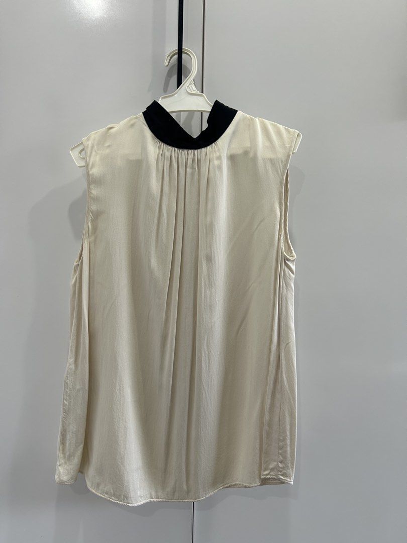 Mango Sleeveless Beige with Black Ribbon-Tie (Category: Sleeveless) located in San Juan City. Submitted by curatedbymae (Listing ID 1456851928, Image 1). Description: Item: Mango Sleeveless Beige with Black Ribbon-Tie - Chest: 13.5 inches - Length (shoulder to hem): 25 inches Size: US-Small RFS: decluttering Mode of Payment: GCASH/MAYA Shipping: Grab/J&T/Lalamove (Buyer will shoulder shipping fee.).