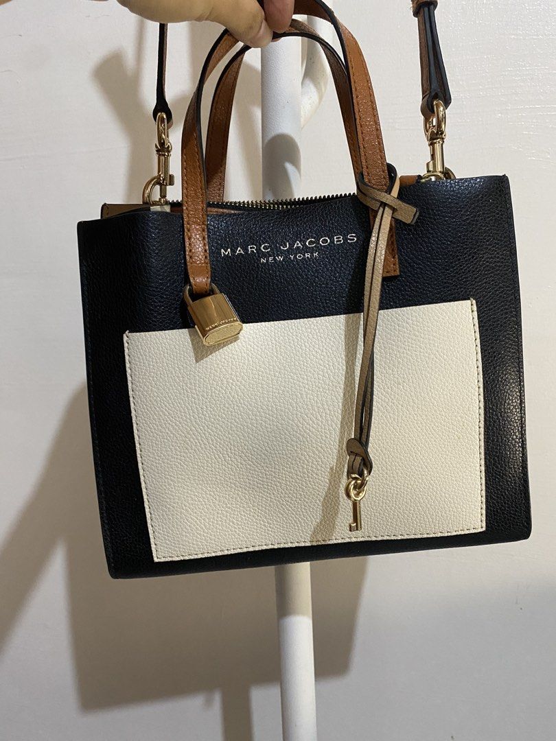 Marc Jacobs Black Leather Colorblock Satchel Bag (Category: Luxury Bags & Wallets) located in Cebu City. Submitted by mickaaay (Listing ID 1456870265, Image 3). Description: - Authentic Marc Jacobs satchel bag - Elegant black and cream leather - Stylish gold hardware with lock and key detail - Convenient adjustable shoulder strap - Secure top zip closure - Interior tag indicates 'Made in Vietnam' - Ideal for everyday use.