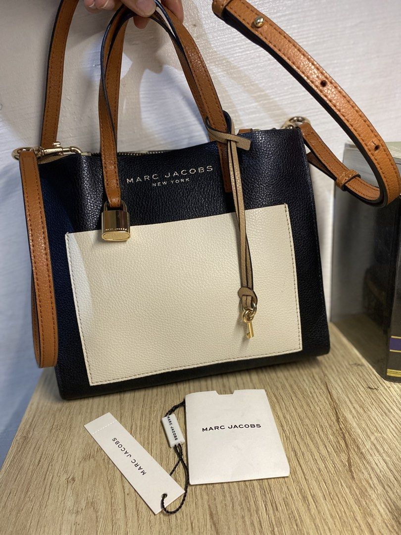 Marc Jacobs Black Leather Colorblock Satchel Bag (Category: Luxury Bags & Wallets) located in Cebu City. Submitted by mickaaay (Listing ID 1456870265, Image 1). Description: - Authentic Marc Jacobs satchel bag - Elegant black and cream leather - Stylish gold hardware with lock and key detail - Convenient adjustable shoulder strap - Secure top zip closure - Interior tag indicates 'Made in Vietnam' - Ideal for everyday use.