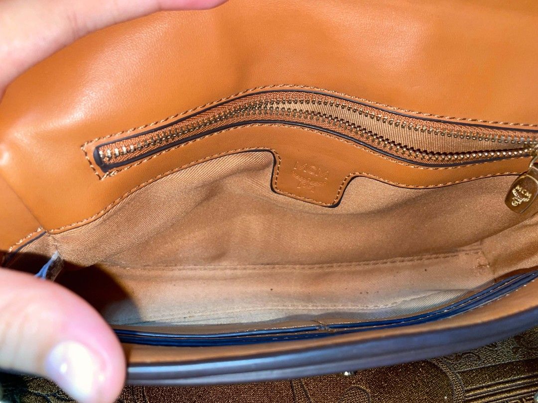 MCM Monogram Clutch Bag (Category: Luxury Bags & Wallets) located in Rosales. Submitted by jmghalib7755166 (Listing ID 1456834770, Image 1). Description: - Authentic MCM clutch - Classic MCM monogram print - Tan leather interior with zippered pocket - Gold-tone hardware - Clasp closure - Ideal for evenings or as a statement piece.