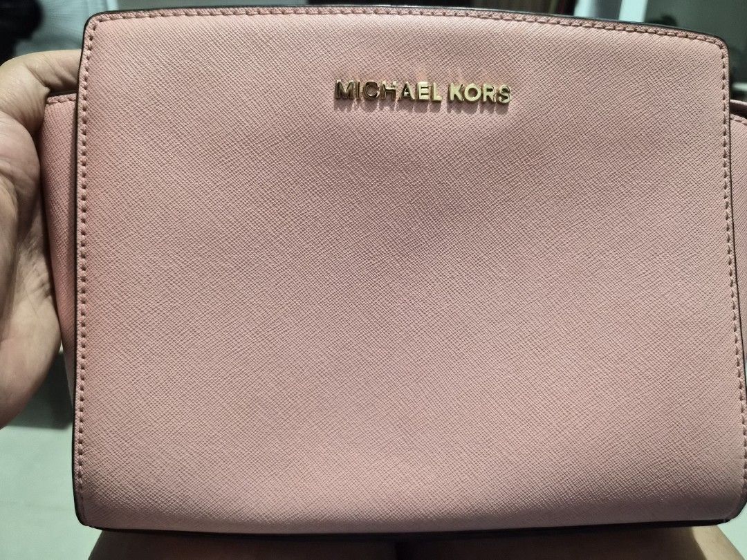 Michael Kors Pink Leather Crossbody Bag (Category: Luxury Bags & Wallets) located in Caloocan City. Submitted by rmdesilva (Listing ID 1456799385, Image 1). Description: Pink Michael Kors crossbody bag. Saffiano leather. Gold hardware details. Interior has a zip pocket and a slip pocket. Comes with a detachable crossbody strap. Great for everyday use..