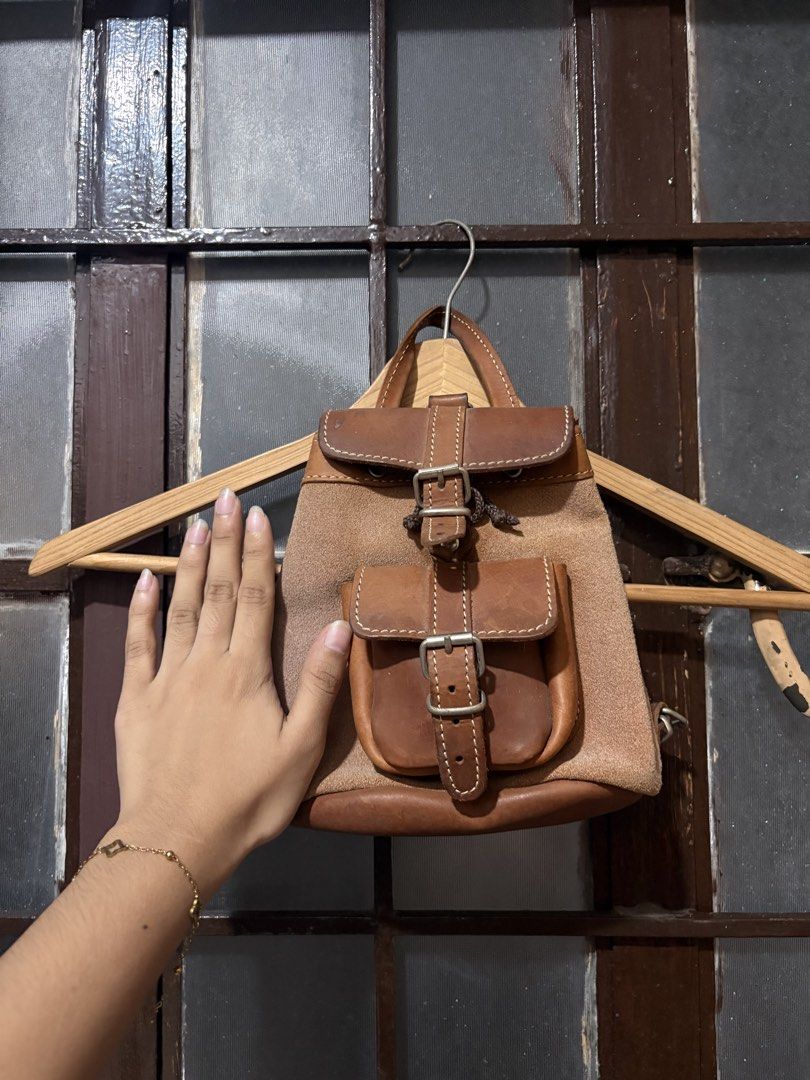 Mini Backpack (Category: Backpacks) located in Las Pinas. Submitted by ainsley.28 (Listing ID 1456938615, Image 2). Description: - Mini backpack from Thriftedcollection - Color: Brown - Material: Combination of leather and suede-like fabric - Closure: Drawstring with buckle flap - Features: Front pocket with buckle closure - Style: Vintage, casual - Condition: Good, pre-loved - Meetup location: Adamson University Senior High School Department.