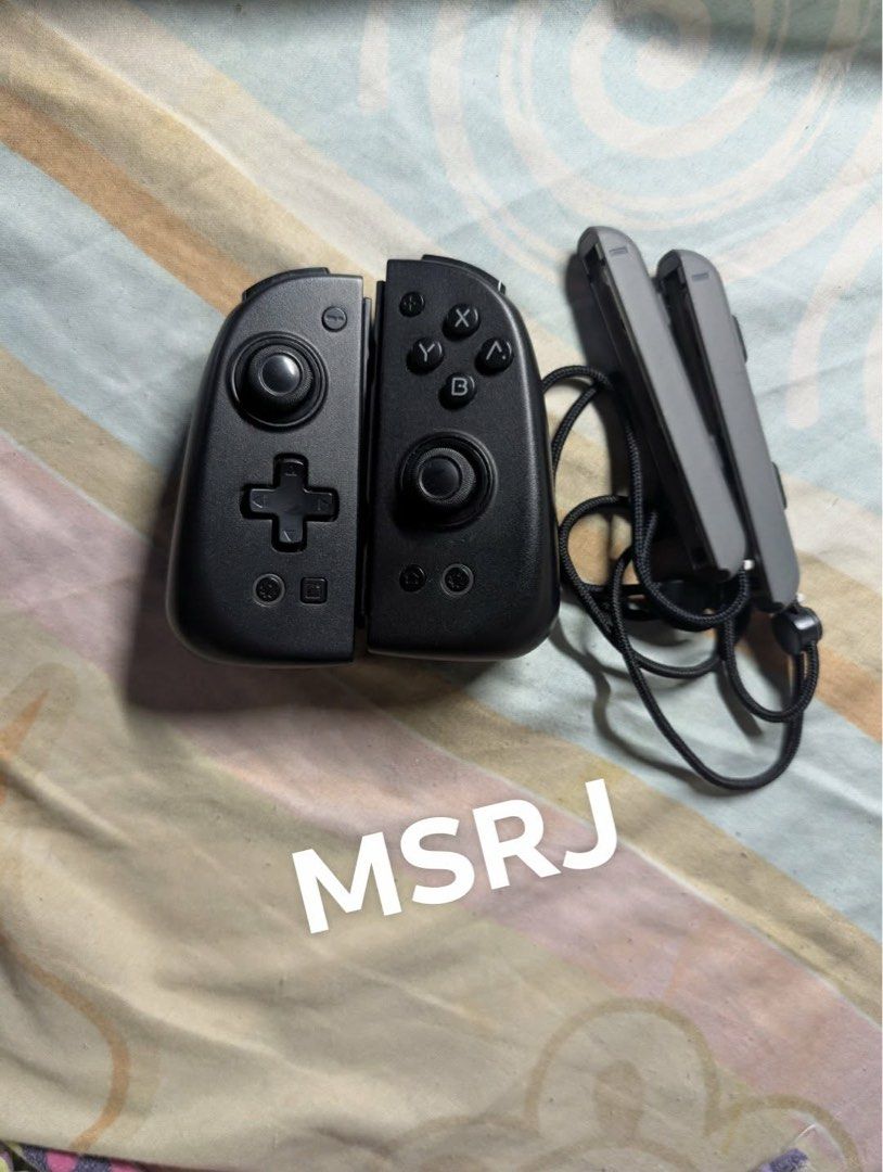 Mobapad Wireless Controller for Nintendo Switch with Case (Category: Controllers) located in Plaridel. Submitted by msrjavier022 (Listing ID 1456857404, Image 2). Description: - Mobapad Wireless Controller for Nintendo Switch - Color: Black and White - Compatible with Nintendo Switch - Includes red carrying case with cute star design - Comes with straps - All buttons and joysticks are in good working condition - Ideal for gaming on the go - Inclu