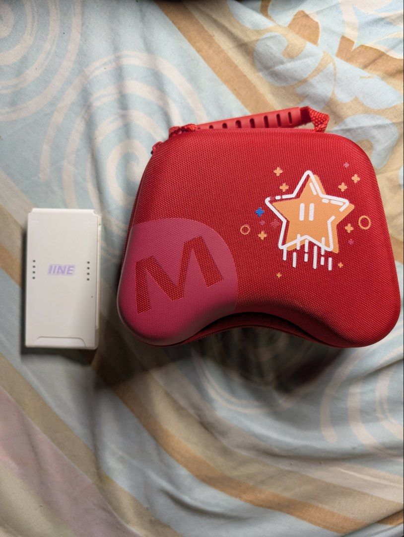 Mobapad Wireless Controller for Nintendo Switch with Case (Category: Controllers) located in Plaridel. Submitted by msrjavier022 (Listing ID 1456857404, Image 3). Description: - Mobapad Wireless Controller for Nintendo Switch - Color: Black and White - Compatible with Nintendo Switch - Includes red carrying case with cute star design - Comes with straps - All buttons and joysticks are in good working condition - Ideal for gaming on the go - Inclu