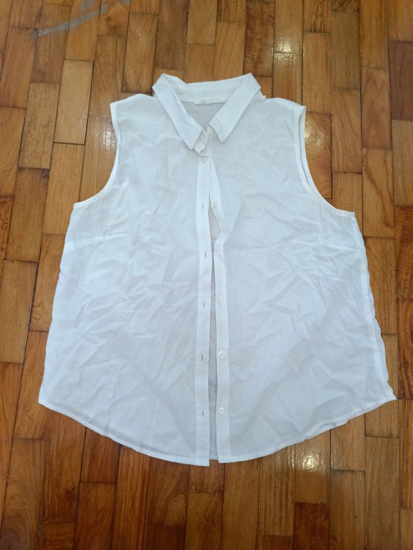 NET Ladies White Sleeveless Collared Button-Up Shirt (Category: Sleeveless) located in Quezon City. Submitted by cheecharon (Listing ID 1456786698, Image 1). Description: - NET Ladies white sleeveless collared shirt - Button-up front - Lightweight material, perfect for layering or standalone wear - Bought in Taiwan - Slight stains in the collar but not visible when worn.