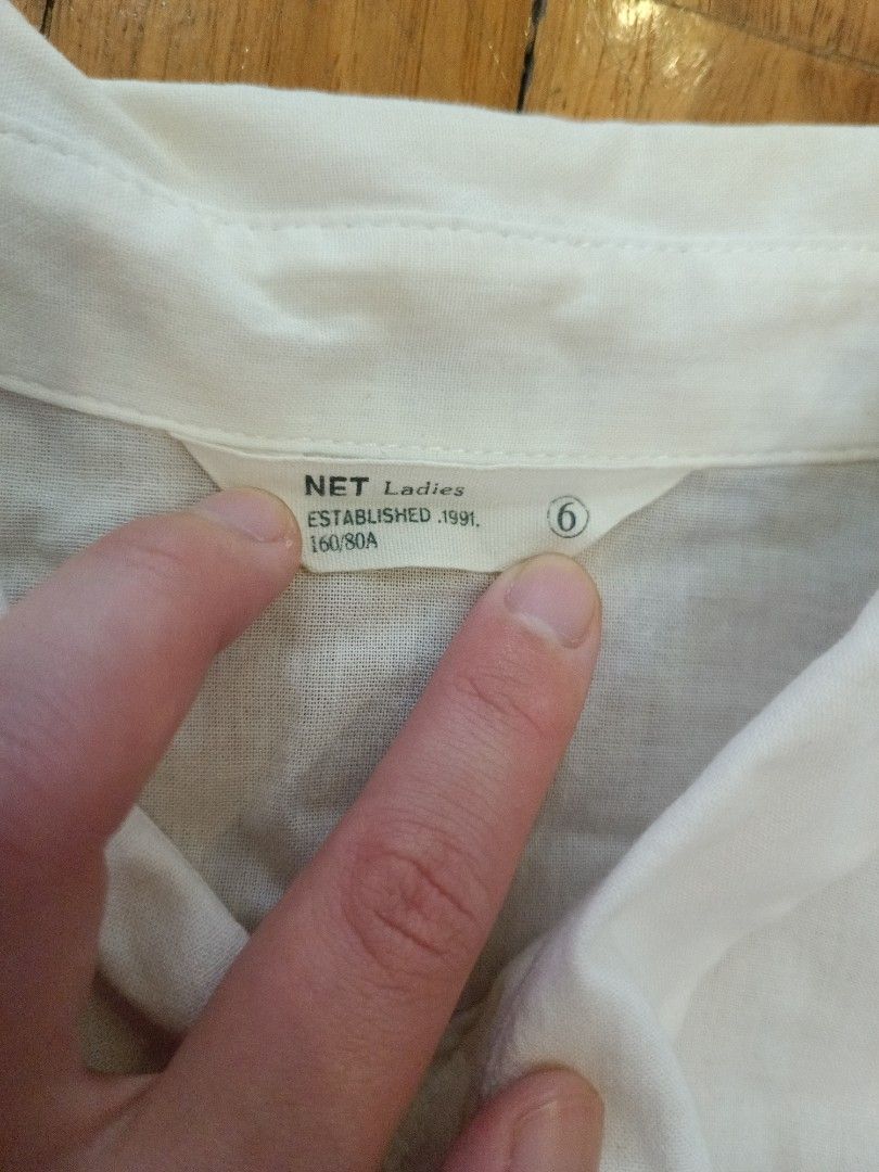 NET Ladies White Sleeveless Collared Button-Up Shirt (Category: Sleeveless) located in Quezon City. Submitted by cheecharon (Listing ID 1456786698, Image 2). Description: - NET Ladies white sleeveless collared shirt - Button-up front - Lightweight material, perfect for layering or standalone wear - Bought in Taiwan - Slight stains in the collar but not visible when worn.