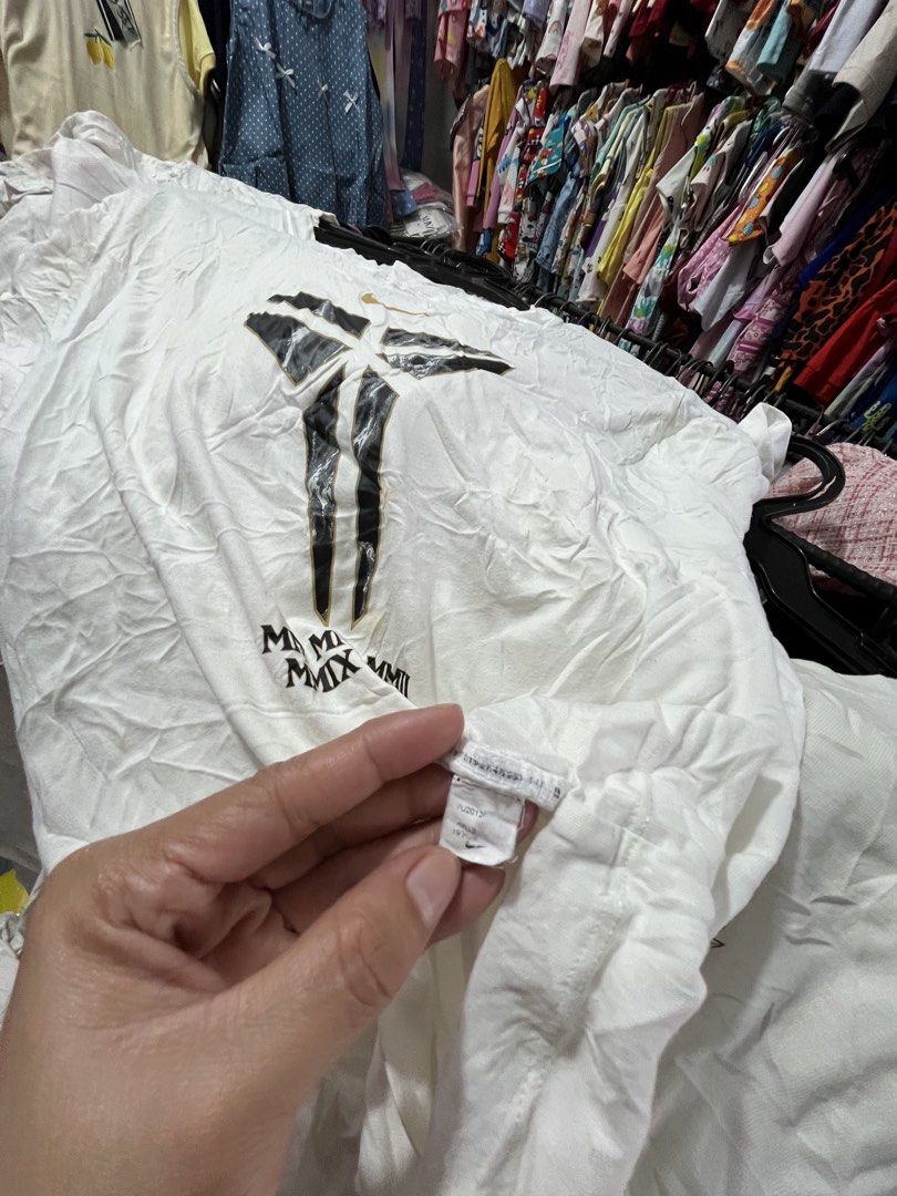 Nike Kobe Bryant Mamba Mentality T-Shirt (Category: Tshirts & Polo Shirts ) located in Quezon City. Submitted by casabalerica (Listing ID 1456800311, Image 3). Description: - White Nike T-shirt - Features Kobe Bryant's Mamba Mentality logo - Includes Roman numerals MMII, MMXI, MMX below the logo - Made from comfortable fabric - Ideal for any Kobe Bryant fan.
