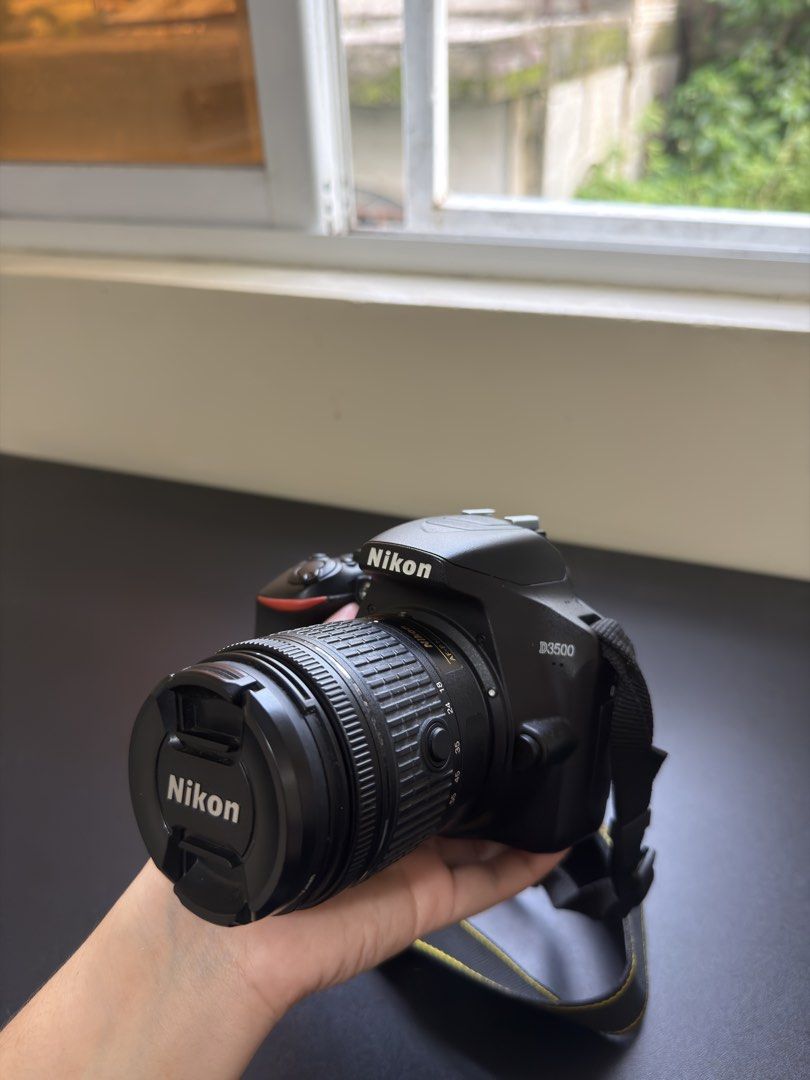 Nikon D3500 DSLR Camera (Category: Cameras) located in Manila. Submitted by livemountain.5b7934 (Listing ID 1456864181, Image 2). Description: Letting go of my Nikon D3500! 🤍 Perfect for beginners, travel photography, and anyone looking to get into DSLR photography. ✨ Nikon D3500 ✨ Lightweight & beginner-friendly ✨ Comes with lens + charger + bag ✨ Barely used / stored for years ✨ Selling as-is 📌 Note: Camera has been stored for a long time and