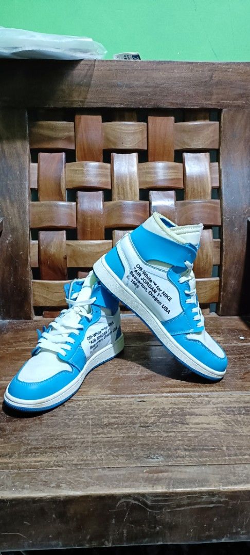 Off-White x Nike Air Jordan 1 UNC (Category: Sneakers) located in Baguio. Submitted by nerissatso45956 (Listing ID 1456909248, Image 2). Description: - Classic high-top sneakers - Iconic Jordan silhouette with Off-White design - Blue and white colorway - "AIR" text detail on midsole - Ideal for collectors and sneakerheads - Statement kicks.