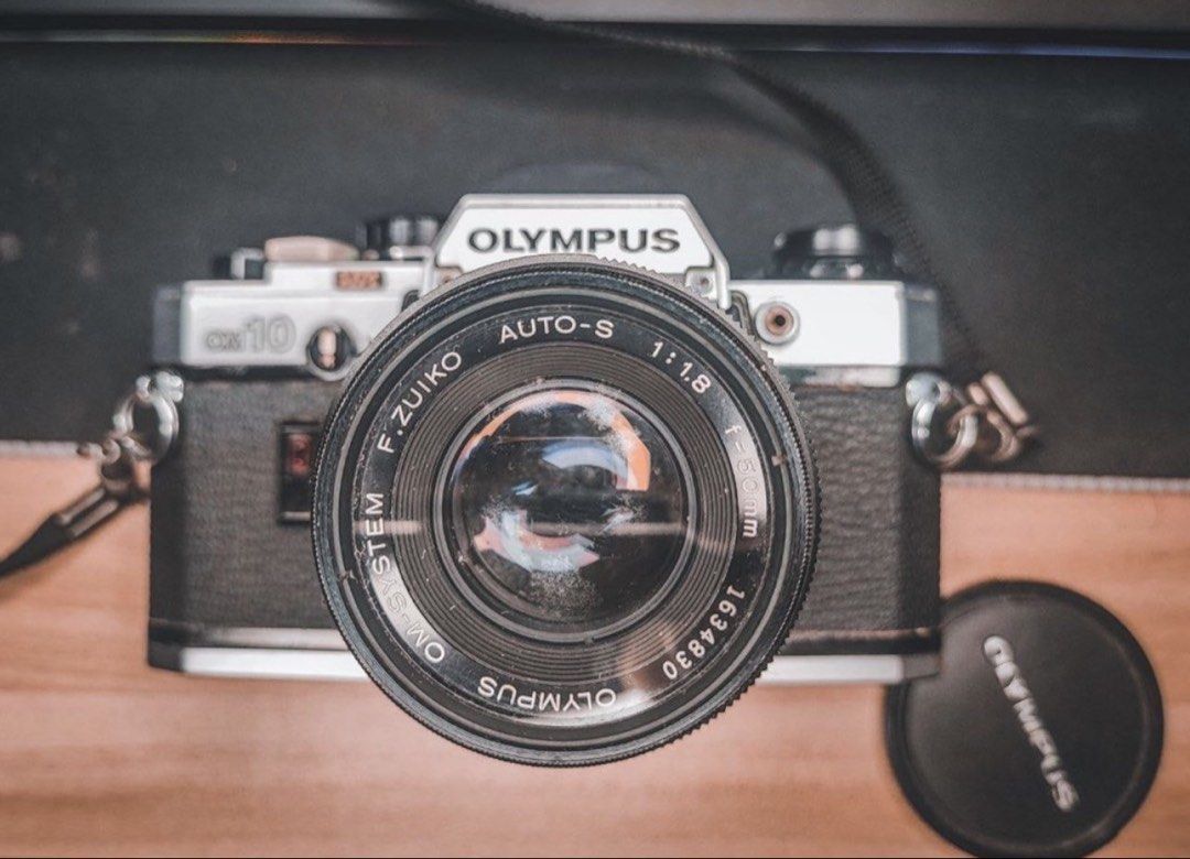 Olympus OM10 with 50mm lens (Category: Cameras) located in Rizal. Submitted by miss2lyps (Listing ID 1456947660, Image 1). Description: Olympus OM10 with 50mm lens Rfs: decluttering Condition: not mint condition, lots of molds and some rust, not sure if working Issue: Stuck film advance lever Inclusions: Original strap F. Zuiko 50mm 1.8 lens with tiffen lens protector Lens cap Olympus electronic flash T20 (functioning) STILL NEGO! .