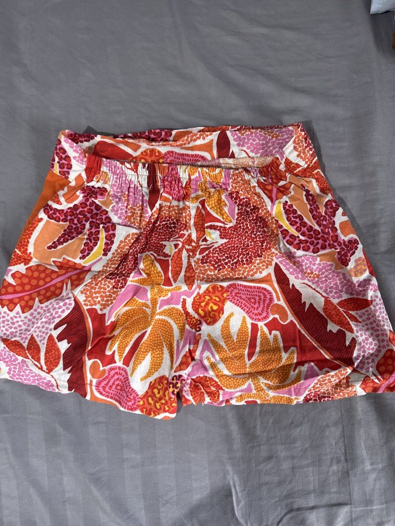 Orange Floral Print Wrap Shorts (Category: Shorts) located in Manila. Submitted by anythinggoeswithcc (Listing ID 1456846711, Image 3). Description: - Vibrant floral print shorts - Features an orange wrap-around detail on the front - Comfortable elastic waistband at the back - Ideal for casual outings and beach days - Easy to pair with any top.