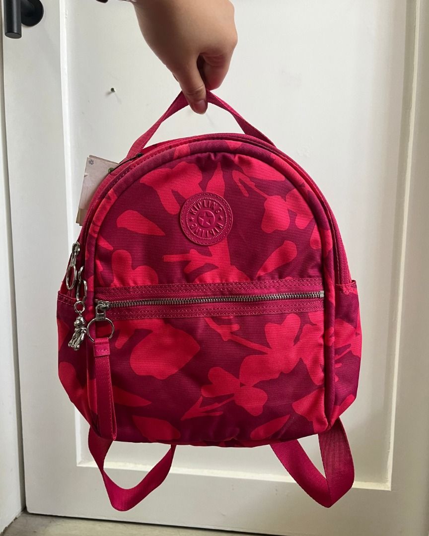 Original Kipling Kae Mini Backpack in Coral Flowers (Category: Backpacks) located in Taguig. Submitted by emgoofficial (Listing ID 1456936013, Image 1). Description: Vibrant and super cute Kipling Kae Mini Backpack in the eye-catching "Coral Flowers" floral print! Lightweight, water-resistant, and packed with functional zip compartments, complete with the signature metal monkey keychain. 📌 Condition: Brand new, never used! Still with original ta