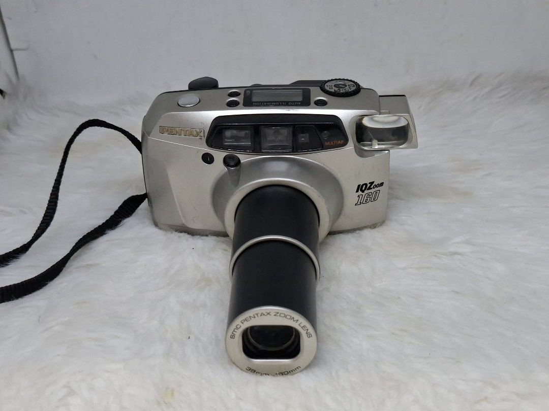 pentax iqzoom 160/espio 160 (Category: Cameras) located in Manila. Submitted by ultimogizmos (Listing ID 1456913362, Image 3). Description: The Pentax IQZoom 160 (also marketed as the Espio 160) is a compact 35mm autofocus point-and-shoot film camera It features a versatile 38mm–160mm zoom lens, built-in multi-mode flash, and automatic exposure handling in a pocketable yet chunky body. tested with dummy film working zoom working flash uses one cr