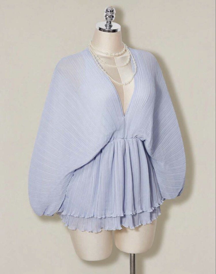 Periwinkle Pleated Chiffon Romper (Category: Blouses) located in Quezon City. Submitted by kleanklutter (Listing ID 1456946105, Image 1). Description: - Dolman sleeves - Fits small-semi large - Garterized sleeves and waist - With inner shorts lining - Cinched waist - Ruffled, tiered hem - Back ribbon tie - All-over pleated texture - Versatile for dressing up or down.