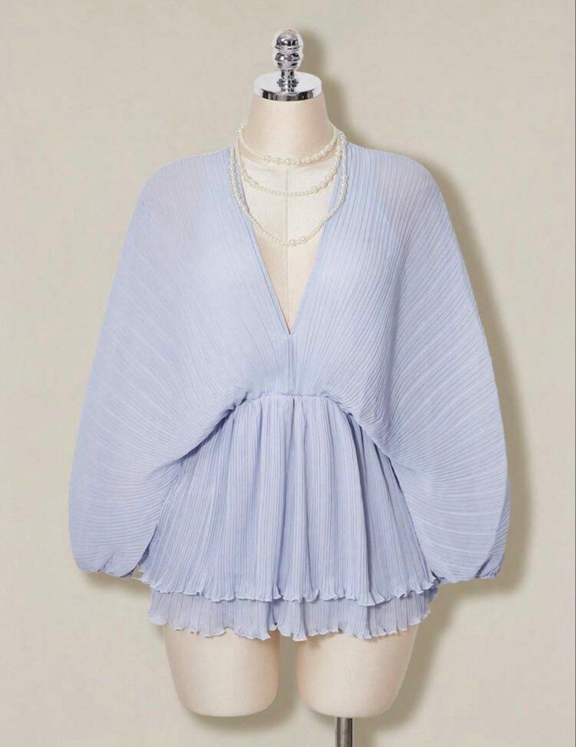 Periwinkle Pleated Chiffon Romper (Category: Blouses) located in Quezon City. Submitted by kleanklutter (Listing ID 1456946105, Image 2). Description: - Dolman sleeves - Fits small-semi large - Garterized sleeves and waist - With inner shorts lining - Cinched waist - Ruffled, tiered hem - Back ribbon tie - All-over pleated texture - Versatile for dressing up or down.