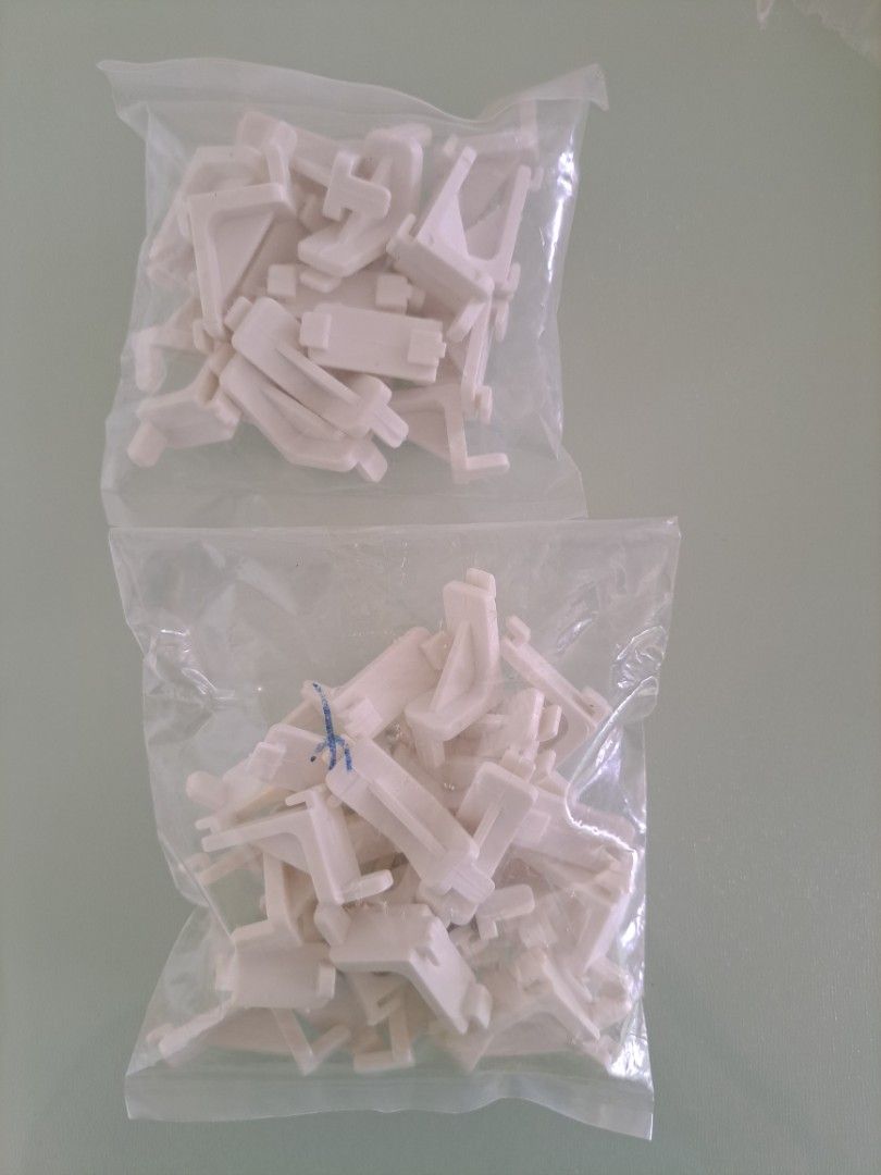 Plastic Shelf Support Brackets (Category: Home Improvement Tools & Accessories) located in Singapore. Submitted by jsnlai (Listing ID 1456830897, Image 1). Description: - support shelf panel inside a fridge, cabinet or shelving unit, with the protruding pins/clips fitting into holes or slots in the cabinet sides. 2 bags of white plastic connectors. .