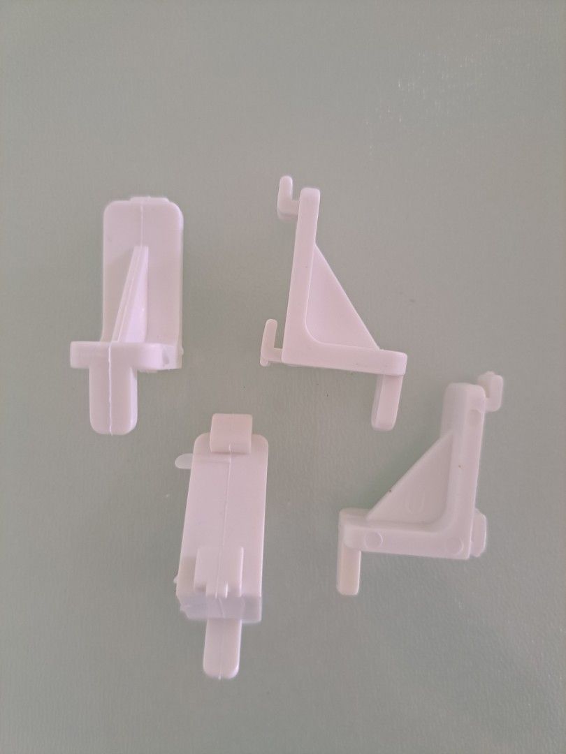 Plastic Shelf Support Brackets (Category: Home Improvement Tools & Accessories) located in Singapore. Submitted by jsnlai (Listing ID 1456830897, Image 2). Description: - support shelf panel inside a fridge, cabinet or shelving unit, with the protruding pins/clips fitting into holes or slots in the cabinet sides. 2 bags of white plastic connectors. .
