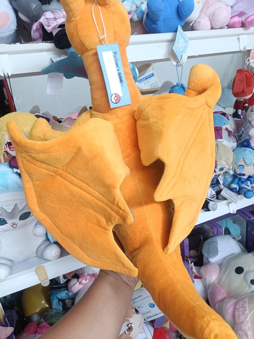 Pokemon Charizard Plush Toy (Category: Plushies & Soft Toys) located in Baguio. Submitted by jamela.joy.shoppe15 (Listing ID 1456951106, Image 3). Description: - Orange Charizard plush toy - Wings are spread out - Brand new with tags attached - Approximately 12 inches tall - Made with soft and cuddly material - Ideal for Pokemon fans, display, or cuddling.