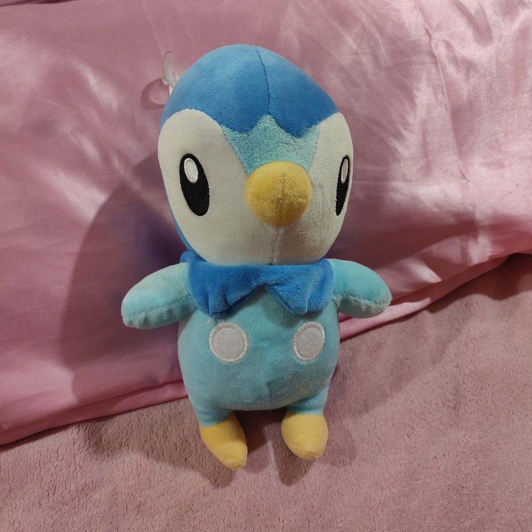Pokemon Piplup Plush Toy (Category: Plushies & Soft Toys) located in Taguig. Submitted by decluttering.ph2020 (Listing ID 1456812047, Image 1). Description: - Adorable light blue Piplup plush toy. - Features yellow feet and beak. - Distinctive white circles on its belly. - Ideal for any Pokemon enthusiast. - Great for decoration or snuggling..