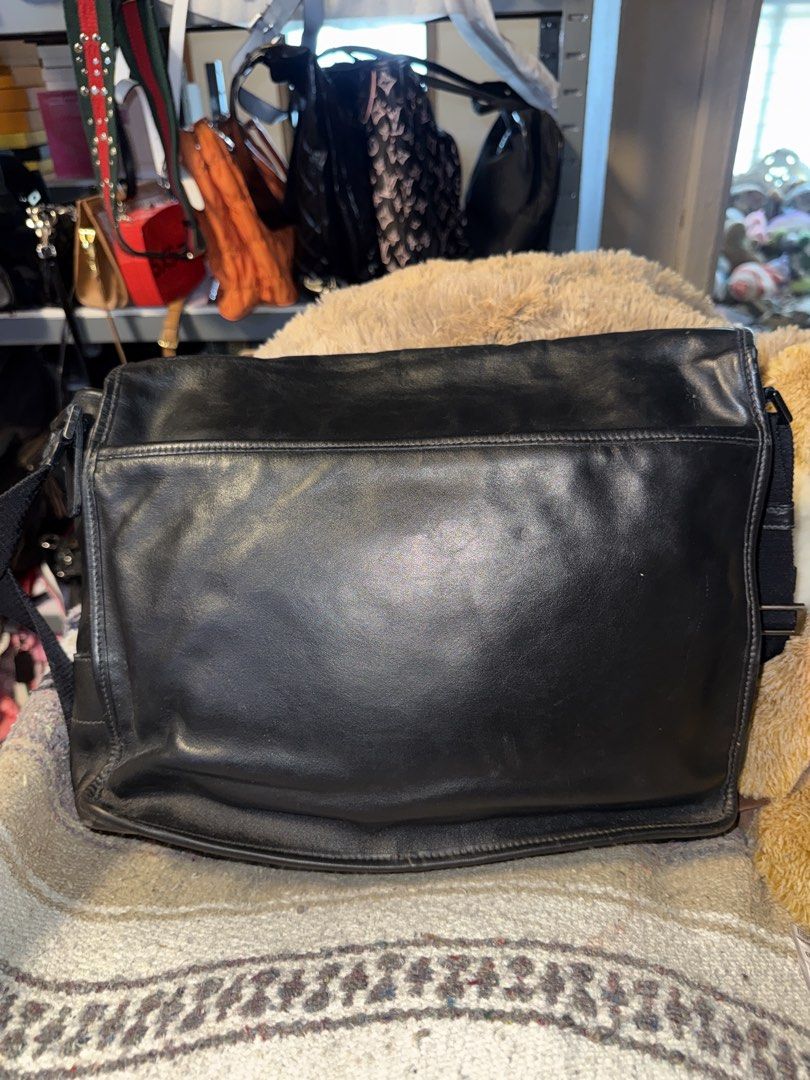 Prada Black Leather Messenger Bag (Category: Tailoring & Restoration) located in Angeles City. Submitted by migs_font29 (Listing ID 1456881587, Image 3). Description: - Authentic black leather Prada messenger bag - Prada Milano logo embossed on front flap - Prada logo printed on adjustable strap - Secure buckle closure - Shows some signs of wear on buckle and strap - Ideal for everyday use.