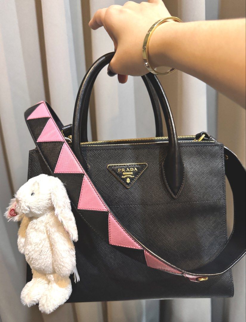 Prada Saffiano Leather Tote Bag with Strap (Category: Luxury Bags & Wallets) located in Cebu City. Submitted by prelovedcornerph2021 (Listing ID 1456782420, Image 2). Description: - Authentic Prada Saffiano Leather Tote Bag - Elegant gold hardware - Pristine interior and exterior condition with minimal signs of wear - Comes with original dust bag and authenticity cards - Includes a chic pink and black geometric strap.