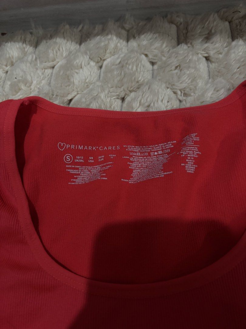 Primark Cares Red Ribbed Cropped Top (Category: Sleeveless) located in Angeles City. Submitted by declutter_q2222 (Listing ID 1456933891, Image 2). Description: - Red ribbed cropped top from Primark - Features short sleeves and a scoop neckline - Made with comfortable and stretchy material - Versatile for layering or wearing on its own - Easily pairs with jeans or shorts.